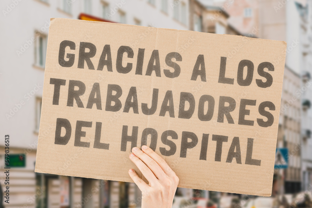 The phrase " Thank you hospital workers " on a banner in hand. The
