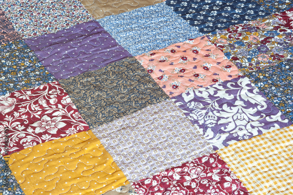 Patchwork print. Quilted quilt with patchwork print. Geometrical pattern. Selective focus Patchwork print. Quilted quilt with patchwork print. Geometrical pattern. Selective focus