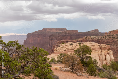 Panoramic aerial view on Colorado River canyon seen from Saffer Canyon Overlook near Moab, Island in the Sky District, Canyonlands National Park, San Juan County, Utah, USA. Clouds and sky in summer