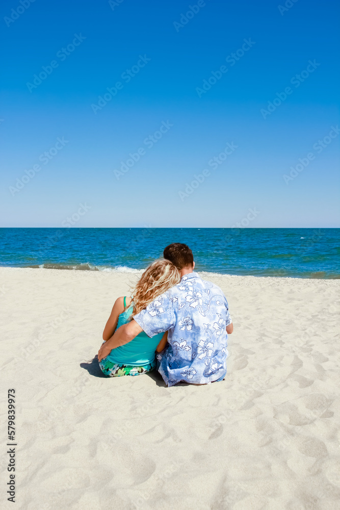 Happy beautiful couple on the sea in the summer on the nature Happy beautiful couple on the sea in the summer on the nature