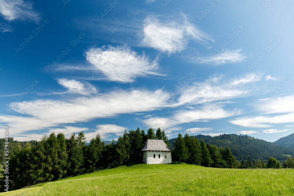 Tiny white hut under blue sky on the green hill in Pieniny mountains