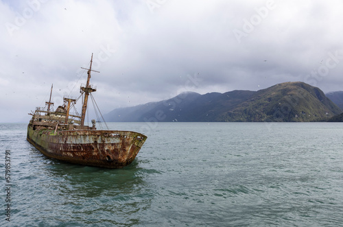 Wreck of MV Captain Leonidas, a freighter that ran aground on the Bajo Cotopaxi (Cotopaxi Bank) in 1968 – viewed from a ferry passing the Messier Channel in Patagonia, Chile 