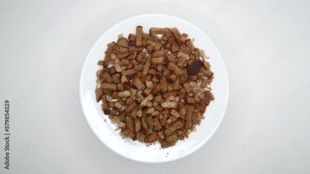 Rye Crackers Rotating On White Background. Bread Crispy Crackers Rotated On A White Flat Plate. Close Up. Top View. 4k, ProRes. Rye Crackers Rotating On White Background. Bread Crispy Crackers Rotated On A White Flat Plate. Close Up. Top View. 4k, ProRes.