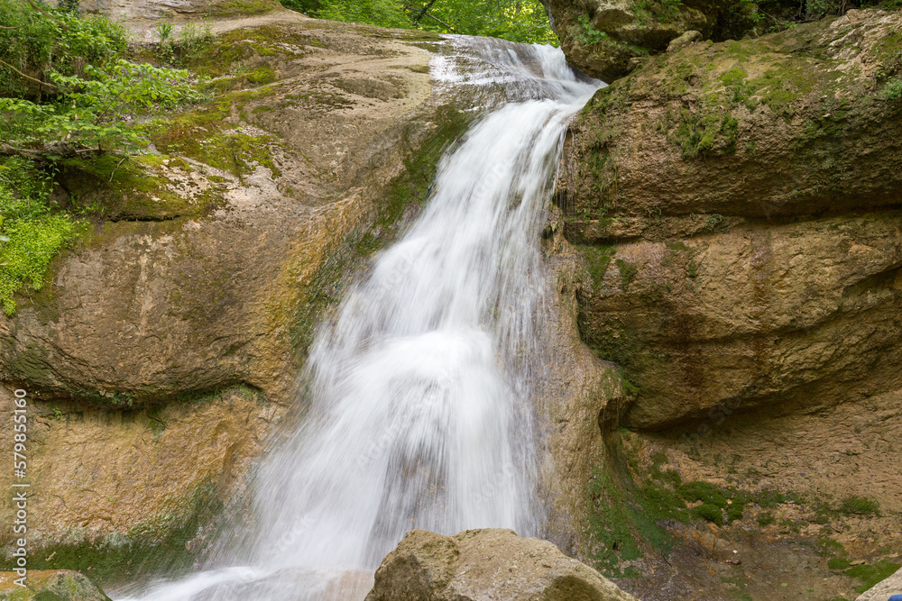 waterfall, cascade of a mountain river in a stone bed, summer season,panoramic view. waterfall, cascade of a mountain river in a stone bed, summer season,panoramic view.
