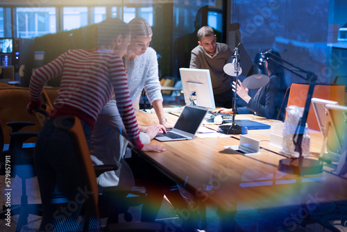 Group of web designers developing a cybersecurity website, app or software late at night in the office
