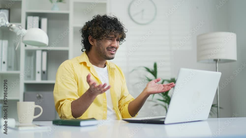 Shocked young office worker or freelancer reading bad news looking at laptop computer Male receives a message with a negative result Stressed man looking at screen confused by problem or crash