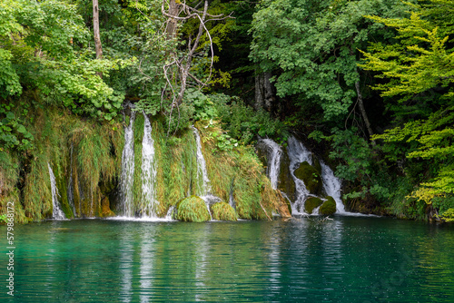 Fototapeta Naklejka Na Ścianę i Meble -  Plitvice, Croatia: View of the beautiful waterfalls of Plitvice Lakes in Plitvice National Park. Green foliage and turquoise water