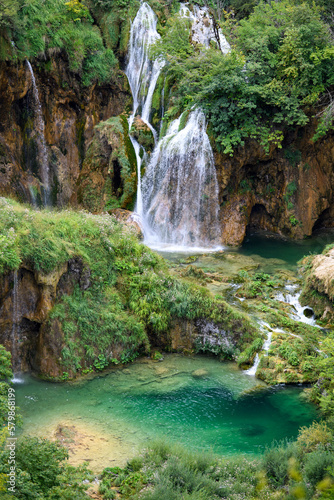 Plitvice, Croatia: View of the beautiful waterfalls of Plitvice Lakes in Plitvice National Park. Green foliage and turquoise water