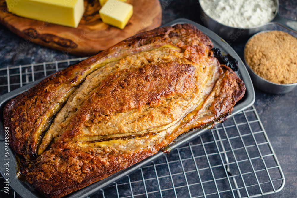 Freshly Baked Banana Bread in Loaf Pan: Banana bread in a nonstick pan on a wire cooling rack Freshly Baked Banana Bread in Loaf Pan: Banana bread in a nonstick pan on a wire cooling rack