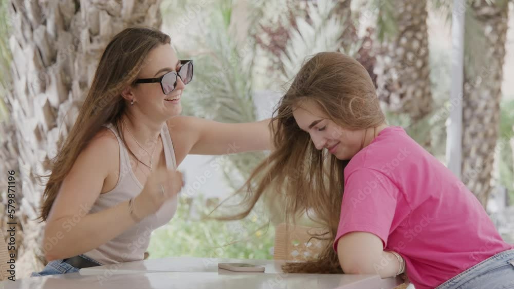 Portrait of happy, caucasian women enjoying summer outdoors. Close-up shot of mother and daughter laughing and looking joyous together. High quality 4k footage Portrait of happy, caucasian women enjoying summer outdoors. Close-up shot of mother and daughter laughing and looking joyous together. High quality 4k footage