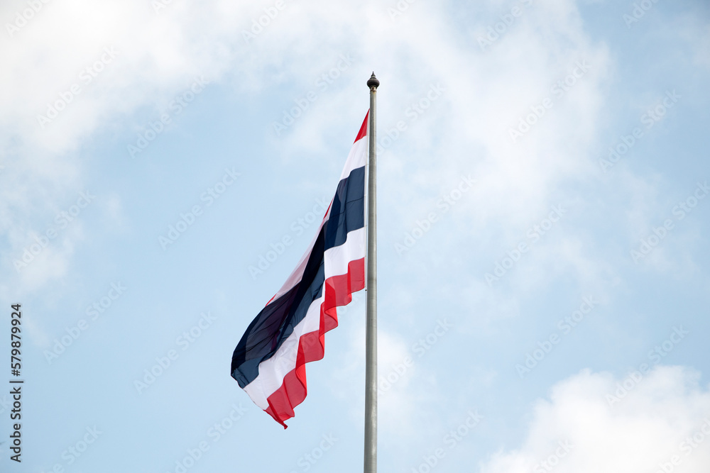 Thailand flag waving in wind with blue sky Thailand flag waving in wind with blue sky