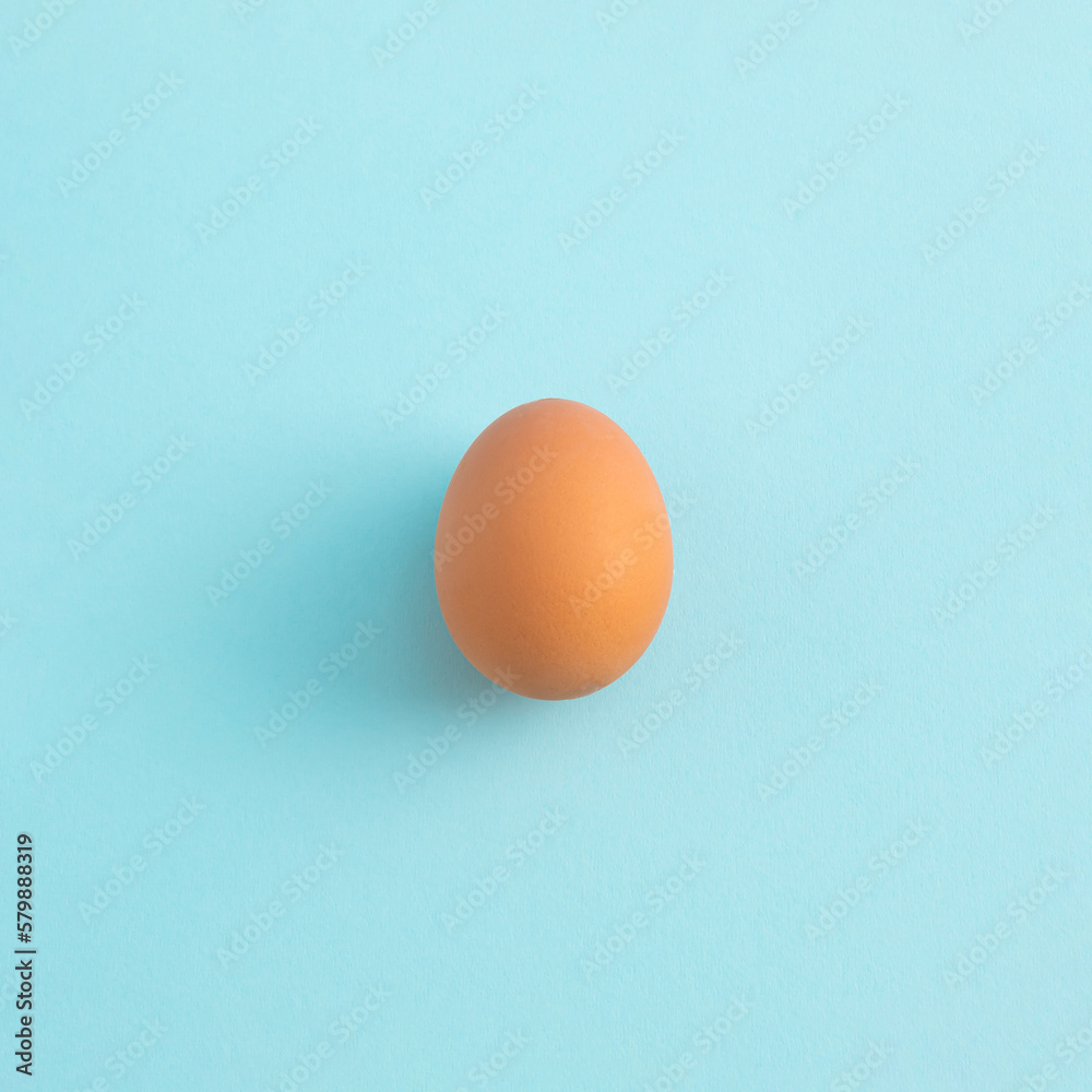 Uncooked egg on pastel blue background. Minimal food concept with copy space. Top view, flat lay. Uncooked egg on pastel blue background. Minimal food concept with copy space. Top view, flat lay.
