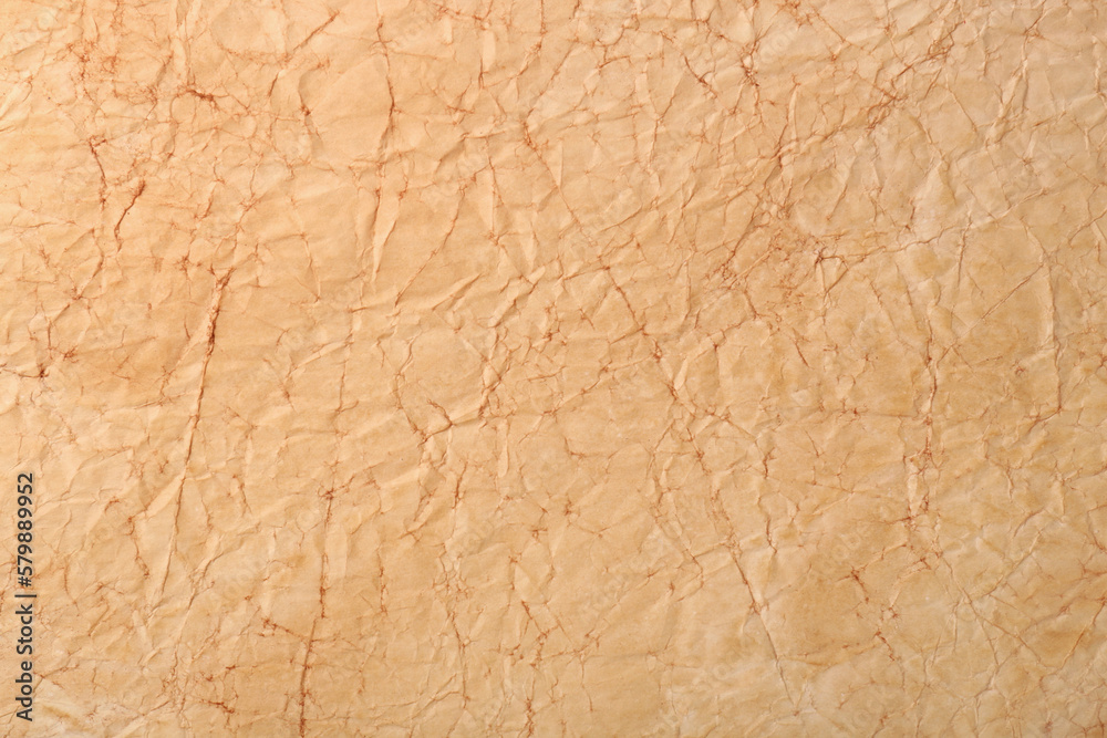 Fototapeta premium Sheet of old parchment paper as background, top view