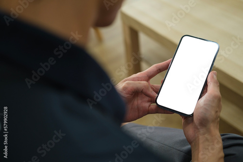 Man holding mock up smart phone. Blank screen for your text message or information content..