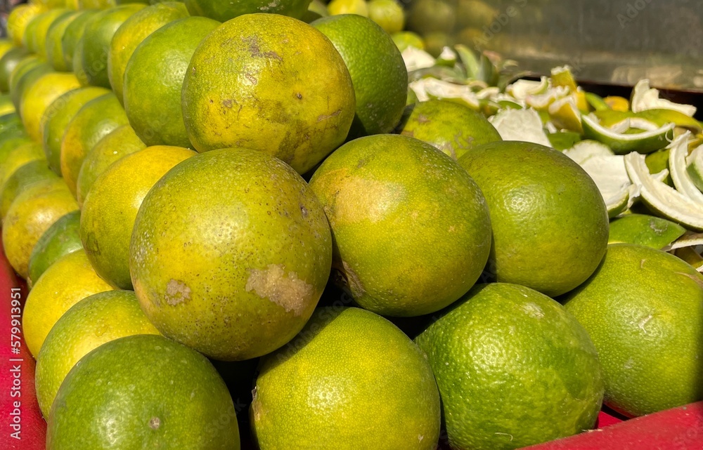 A close-up of fresh green lemons