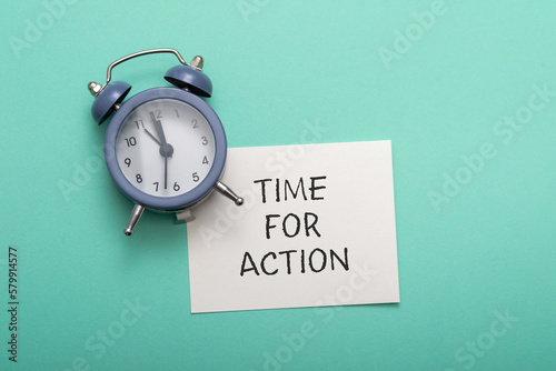Phrase Time for Action with alarm clock on azure background