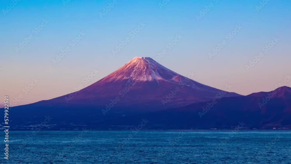 A sunset timelapse of Mt.Fuji near Suruga coast in Shizuoka wide shot zoom A sunset timelapse of Mt.Fuji near Suruga coast in Shizuoka wide shot zoom