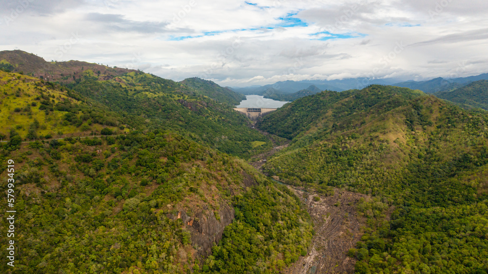 Aerial view of Hydroelectric dam in Sri Lanka located in a mountainous area among tropical vegetation. Aerial view of Hydroelectric dam in Sri Lanka located in a mountainous area among tropical vegetation.