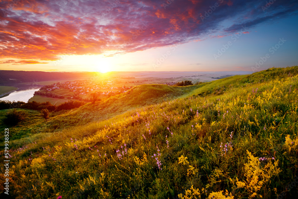 Colorful sunset and hilly meadow in golden evening light near Dniester river. Ukraine, Europe.