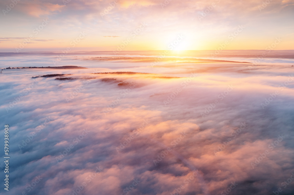Obraz premium Fantastic scene of plain in the fog from a bird's eye view. Drone shot.