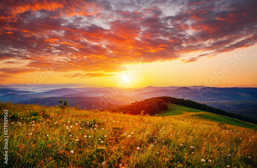 The sun sets over the mountain ranges. Carpathian mountains  Ukraine  Europe.
