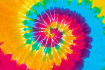 spiral tie dye pattern hand dyed on cotton fabric abstract texture background.