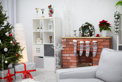 Bright living room with Christmas decorations and gifts under the tree.