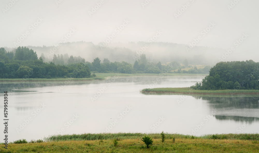 Serene landscape with a lake in the fog