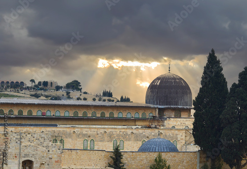 Ancient Dome of Mosque on Temple Mount in Jerusalem, clouds and sunbeams just...