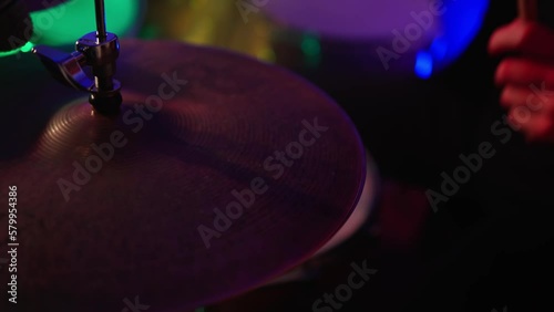 Close Up Portrait of Drummer Playing Drums, colored lights