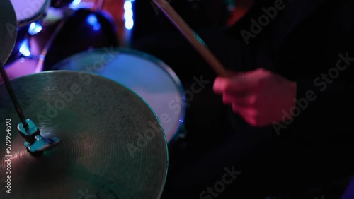  man plays a drum kit,Music party,colored lights