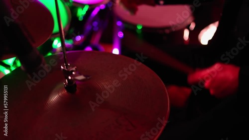 Close Up Portrait of Drummer Playing Drums, colored lights