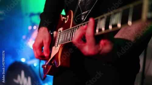 Man is playing guitar on stage.close up,Animation multicolor lights