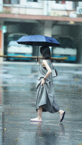 The people walking with umbrella in the rainy day
