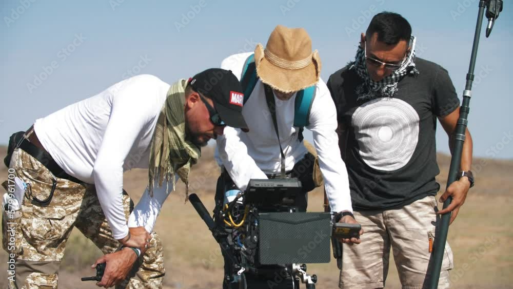 Director and his assistants are at the camera on the set of the film. Movie production Director and his assistants are at the camera on the set of the film. Movie production