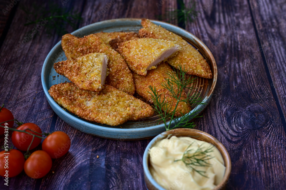 Crispy oven baked chicken breast with sesame seeds and ketchup. Breaded chicken fillets with chilly peppers and fresh basi on wooden rustic background
Crispy oven baked chicken breast with sesame seeds and ketchup. Breaded chicken fillets with chilly peppers and fresh basi on wooden rustic background