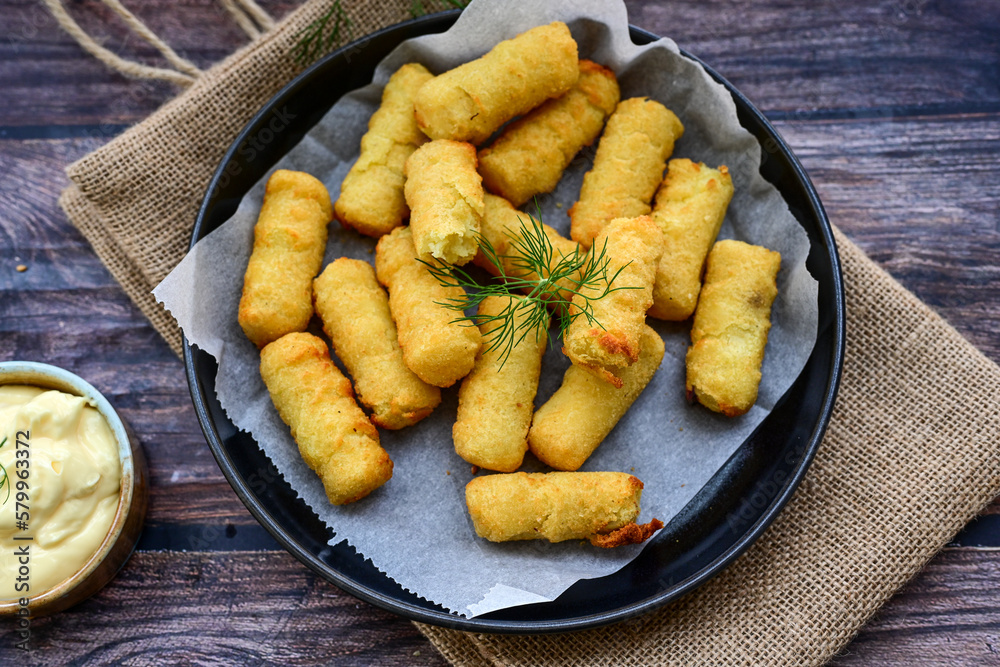  Traditional fried  Potato Croquettes with Cheese  dipping sauce on wooden board
