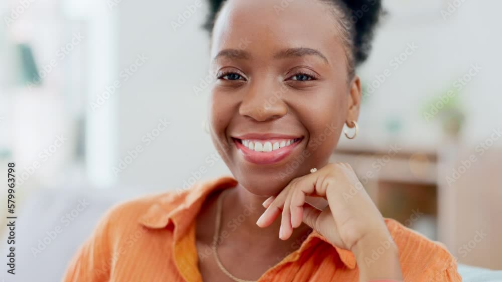 Happy, face and black woman laughing on a sofa, relax and cheerful against blurred background. Portrait, smile and female chilling in living room, carefree and peaceful on off day or weekend at home Happy, face and black woman laughing on a sofa, relax and cheerful against blurred background. Portrait, smile and female chilling in living room, carefree and peaceful on off day or weekend at home