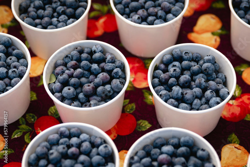 High angle view of blueberries in containers for sale on table at store photo