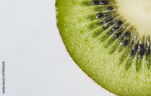 Close-up of kiwi slice on white background photo