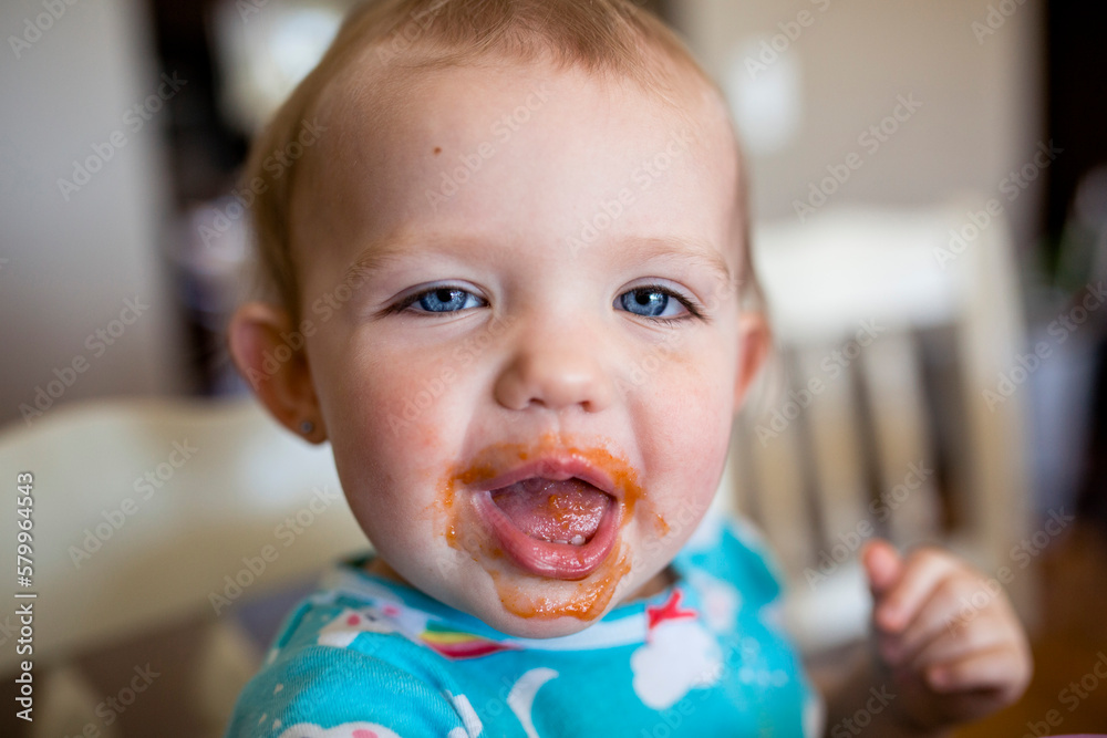 Portrait of cute baby girl with messy mouth sitting at home Portrait of cute baby girl with messy mouth sitting at home