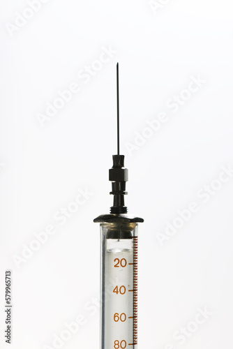 Close-up of syringe on white background photo