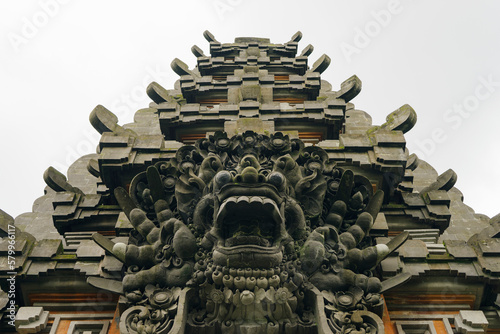 Low angle view of demon stone sculptures at temple against clear sky photo