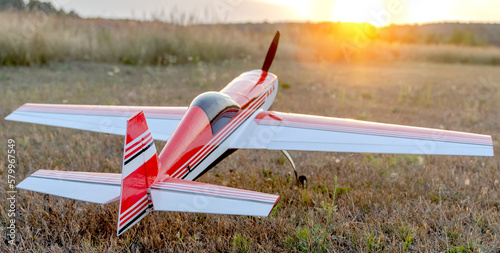 airplane model on the runway at sunset