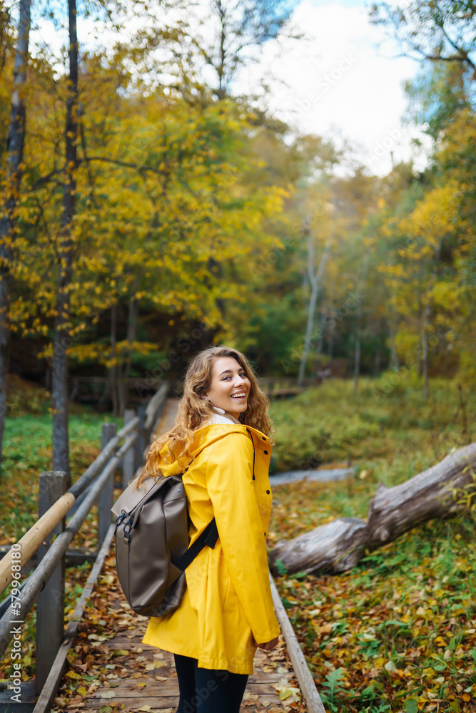 Portrait of young woman walking in  the forest. Travelling, lifestyle, adventure.
