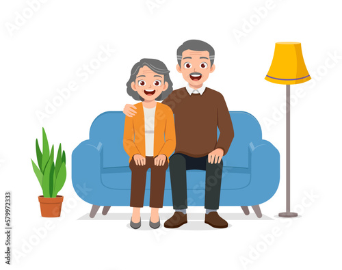 happy old couple sit on sofa and loving together