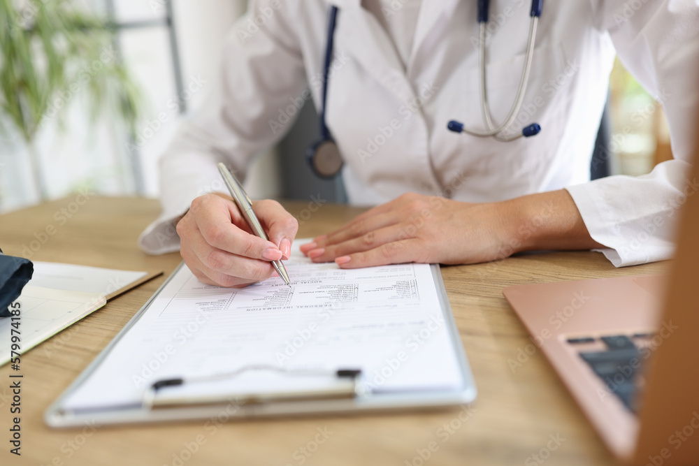 Doctor working with medical documents in clinic.