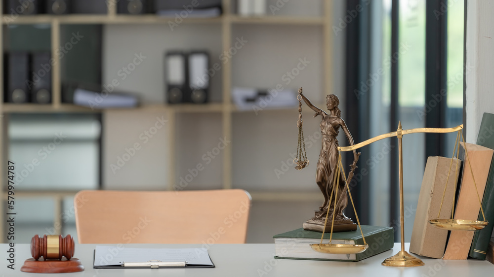 Legal and law concept. Statue of Lady Justice with scales of justice and wooden judge gavel on wooden table. Panoramic image statue of lady justice.