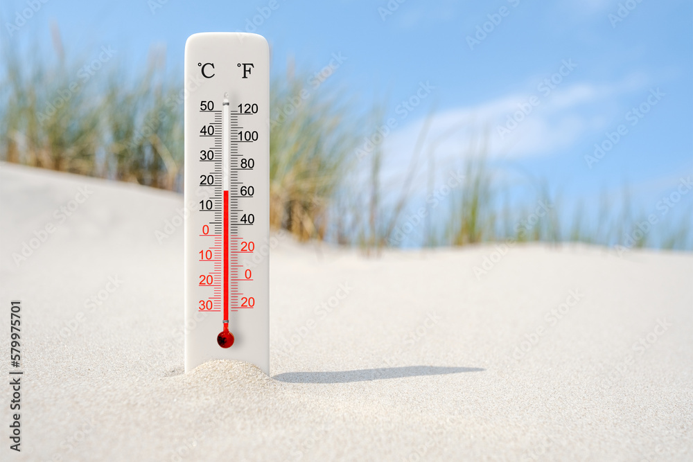 Hot summer day. Celsius and fahrenheit scale thermometer in the sand. Ambient temperature plus 18 degrees - obrazy, fototapety, plakaty 