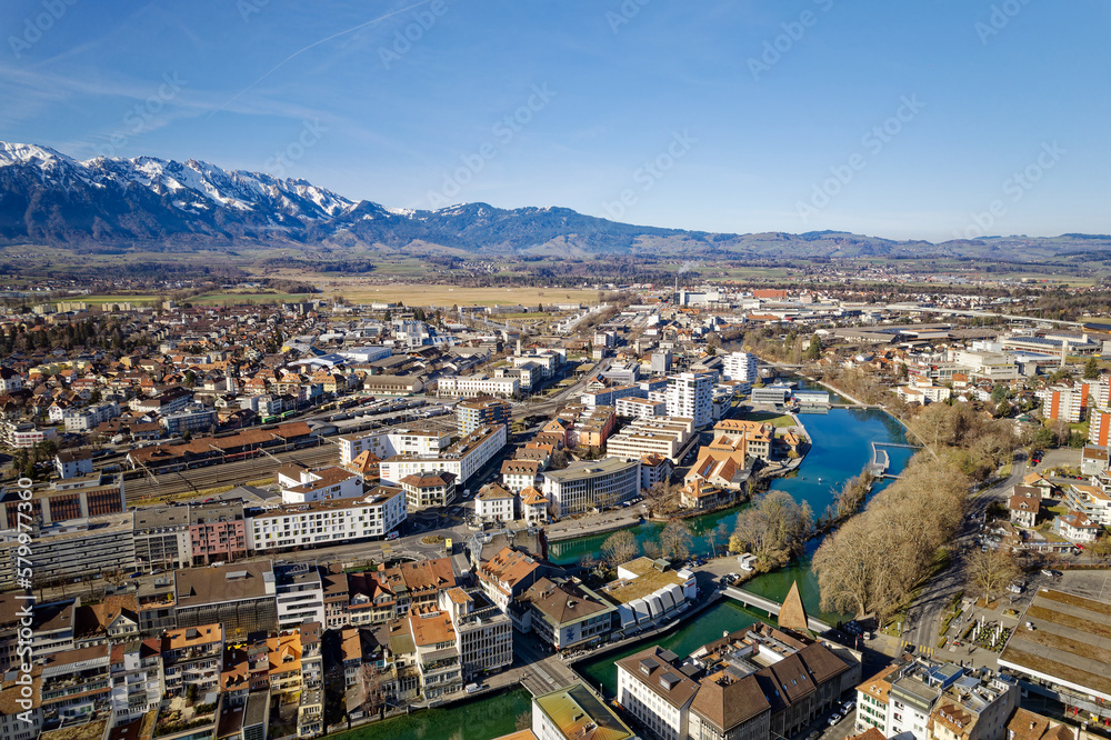 Aerial view of City of Thun with railway station and Aare River an beautiful landscape on a sunny winter day. Photo taken February 21st, 2023, Thun, Switzerland.